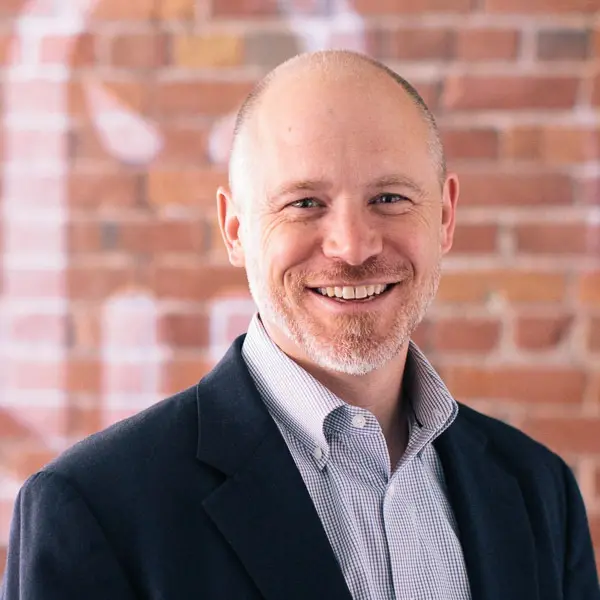 A man wearing a blue jacket and a blue shirt.