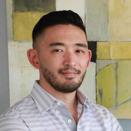 A man with a beard and a striped shirt.